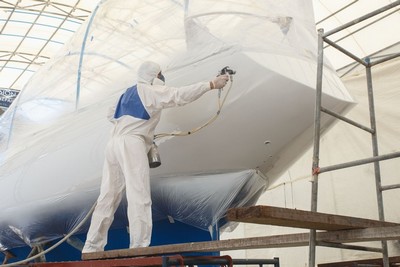Man-Spraying-Paint-on-the-Boat